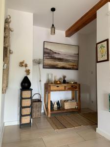 a living room with a table and a painting on the wall at Lavender Cottage in Sucha Rzeczka