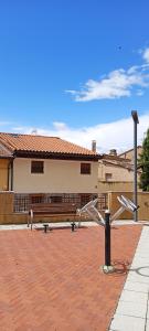 a park with a bench and a street light at Casa TEO in Entrena