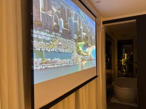 a projection screen on a wall in a hotel room at Exclusive Cabanas in Serra Negra