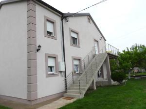 a white building with stairs on the side of it at Boskovic Apartments in Podgorica