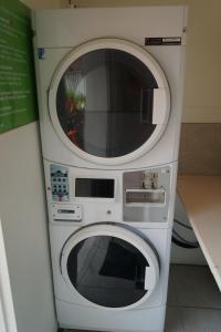 two microwaves stacked on top of each other at Port Douglas Motel in Port Douglas
