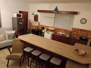 a kitchen with a bar with stools and a counter top at Family beachfront cottage in Tergniet