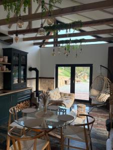 a living room with a table and some chairs at Adăpost Transalpina in Căpîlna