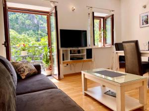 a living room with a couch and a table at Fiumera Kotor Apartment in Kotor