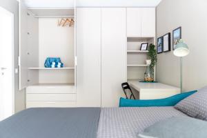 a bedroom with a blue bed and white cabinets at Locarno Center - Free Parking, Netflix and WiFi in Locarno