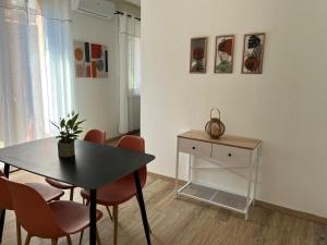 a dining room with a black table and chairs at Appartamento in centro by La Dolce Riva in Lugo