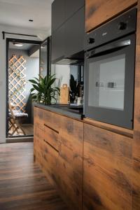 a kitchen with a large entertainment center with a tv at Benvenuti DELUXE in Belgrade