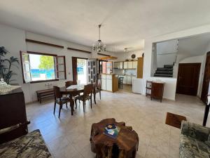 a living room and kitchen with a table and chairs at Sea View in Kámpos
