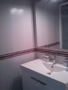 a bathroom with a white sink and a mirror at Entre mer et centre-ville in La Tranche-sur-Mer