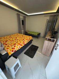 a bedroom with a large bed and a table at Ferienhaus Rovine in Ivišovo Greblje