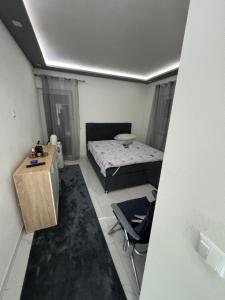 a small bedroom with a bed and a table and a chair at Ferienhaus Rovine in Ivišovo Greblje +18 photos