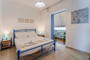 a bedroom with a bed and a large window at THE HOWARD PLACE - ENTIR HOME WITH A SEA VIEW FOR 5 GUESTs in Agios Nikolaos