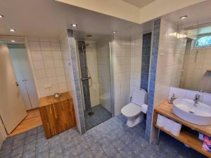a bathroom with a toilet and a shower and a sink at Bed Breakfast in Stockholm in Stockholm