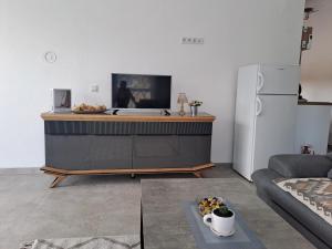 a living room with a refrigerator and a table at Relax House in Vrančići