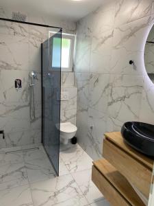 a bathroom with a shower and a toilet at Emily in Slime +44 photos