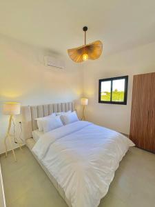 a bedroom with a large white bed and a window at Villa Elysia in Ech Chaïbat +56 photos