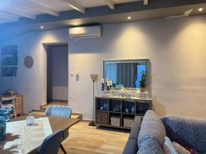 a living room with a table and a mirror at Koroni Dream House in Koroni