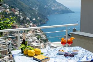 a table on a balcony with a view of the ocean at La Casa di Bruno in Positano