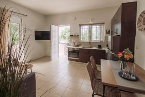 a kitchen and dining room with a table and chairs at Summer Blue Apartments Chania in Chania Town