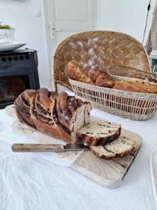 a basket of bread on a table with a basket of bread at La Maison Ânanda in Aigre +65 photos