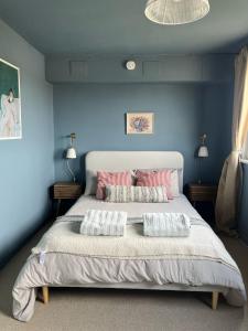 a bedroom with a large bed with two pillows at Neuk Nest,serene 2 bedroom apartment in Anstruther in Anstruther