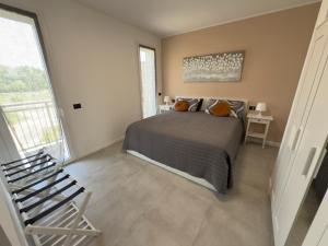 a bedroom with a bed and a large window at Salix Aurea in San Martino Siccomario