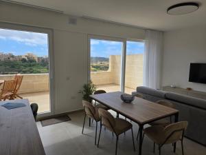 a living room with a table and a couch at Luxury Apartment Valley Views C6 in Xagħra