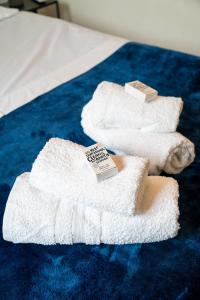 a pair of towels on a blue carpet at kavouraki 1 in Khlóï