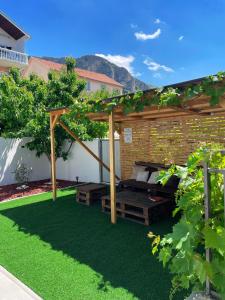 a backyard with a picnic table and a pergola at Hills Holiday House in Mostar