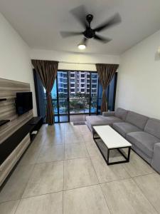 a living room with a couch and a ceiling fan at Atlantis Residence Melaka by HK 2 BR in Tranquerah +9 photos