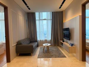 a living room with a couch and a tv at Sky Suites City Centre in Kuala Lumpur