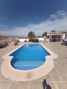 a swimming pool in the middle of a patio at Bonita Casita Luz del Sol in Arboleas