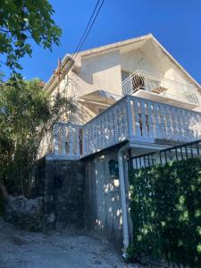 a house with a blue deck on the side of it at Kotor Bay Villa in Tivat +8 photos