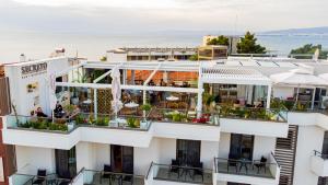 a view of a building with tables and chairs at Sky Boutique Hotel in Perea