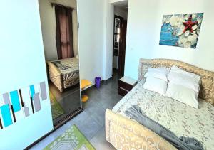 a small bedroom with a bed and a mirror at شاليه إطلالة مميزة in El Alamein +8 photos