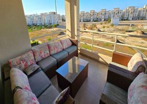 a living room with a couch and a table at شاليه إطلالة مميزة in El Alamein