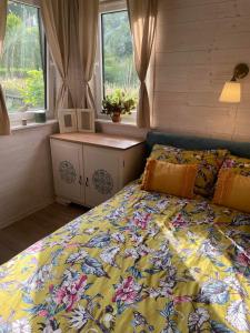 a bedroom with a bed with a colorful bedspread at Oddech in Miłków