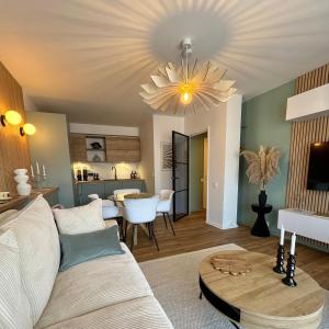 a living room with a couch and a table at Sweet Dove - Cocon de charme, balcon & parking privé in Chambéry +27 photos