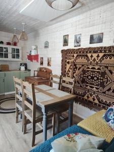 a dining room with a wooden table and chairs at Oddech in Miłków