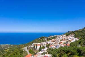 a town on a hill near the ocean at The Mulberry House in Mirsíni