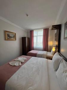 Postel nebo postele na pokoji v ubytování Hotel Topkapı