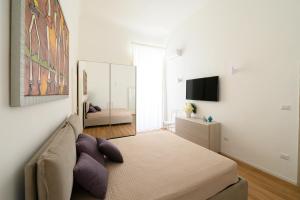 a bedroom with a bed and a television in it at Palanto a Trani in Trani