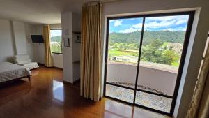 a room with a large glass door with a view at Hotel Imperial in Chiquinquirá