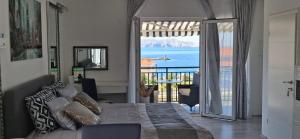 a bedroom with a bed and a view of the ocean at Beautyful sea view 6 luxury studio Danijela 1 in Senj
