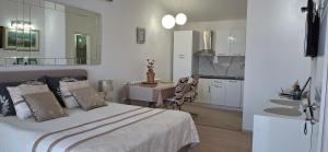 a bedroom with a bed and a kitchen with a sink at Beautyful sea view 6 luxury studio Danijela 1 in Senj +124 photos