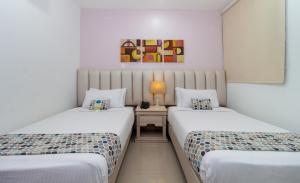 Postel nebo postele na pokoji v ubytování Hotel Costa Bonita