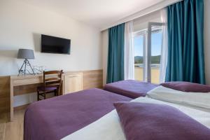 Postel nebo postele na pokoji v ubytování Hotel Porat