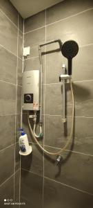 a bathroom with a soap dispenser on a wall at BELL Suites KLIA Comfort Stay - Studio in Sepang