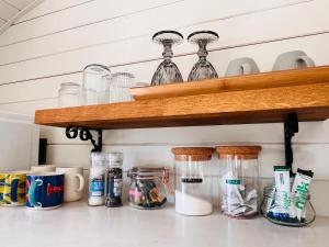 a kitchen counter with glass jars on a shelf at The Oyster Bed in Whitstable
