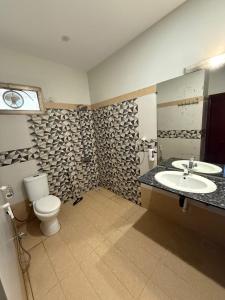 a bathroom with a toilet and a sink at Amada Family Guest House in Karachi +49 photos